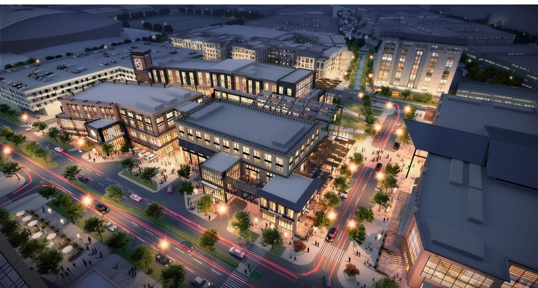 Aerial rendering of Frisco Station. There are shops, apartment buildings, and a parking garage.