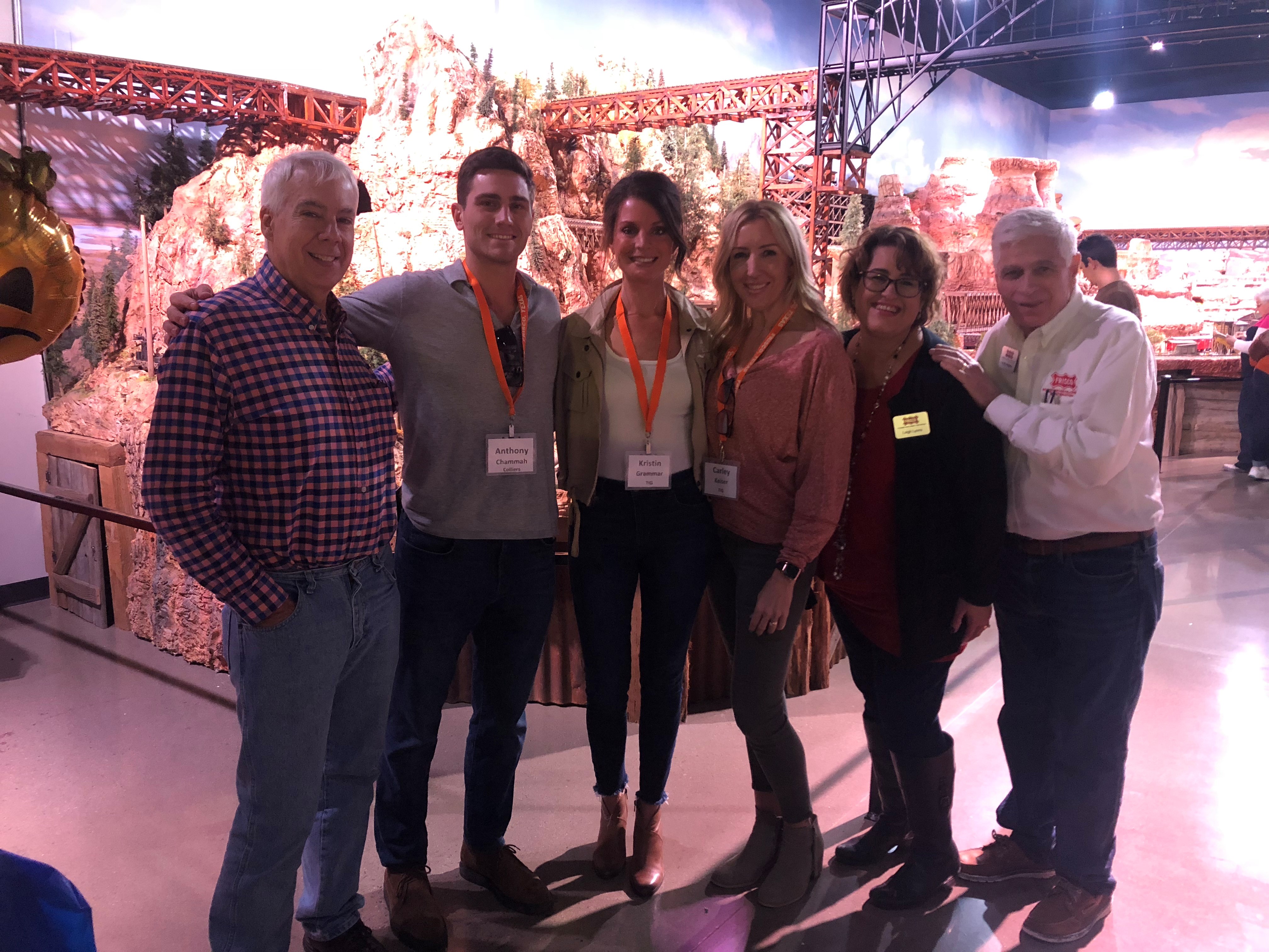 Six people gather for a photo at Train Topia.