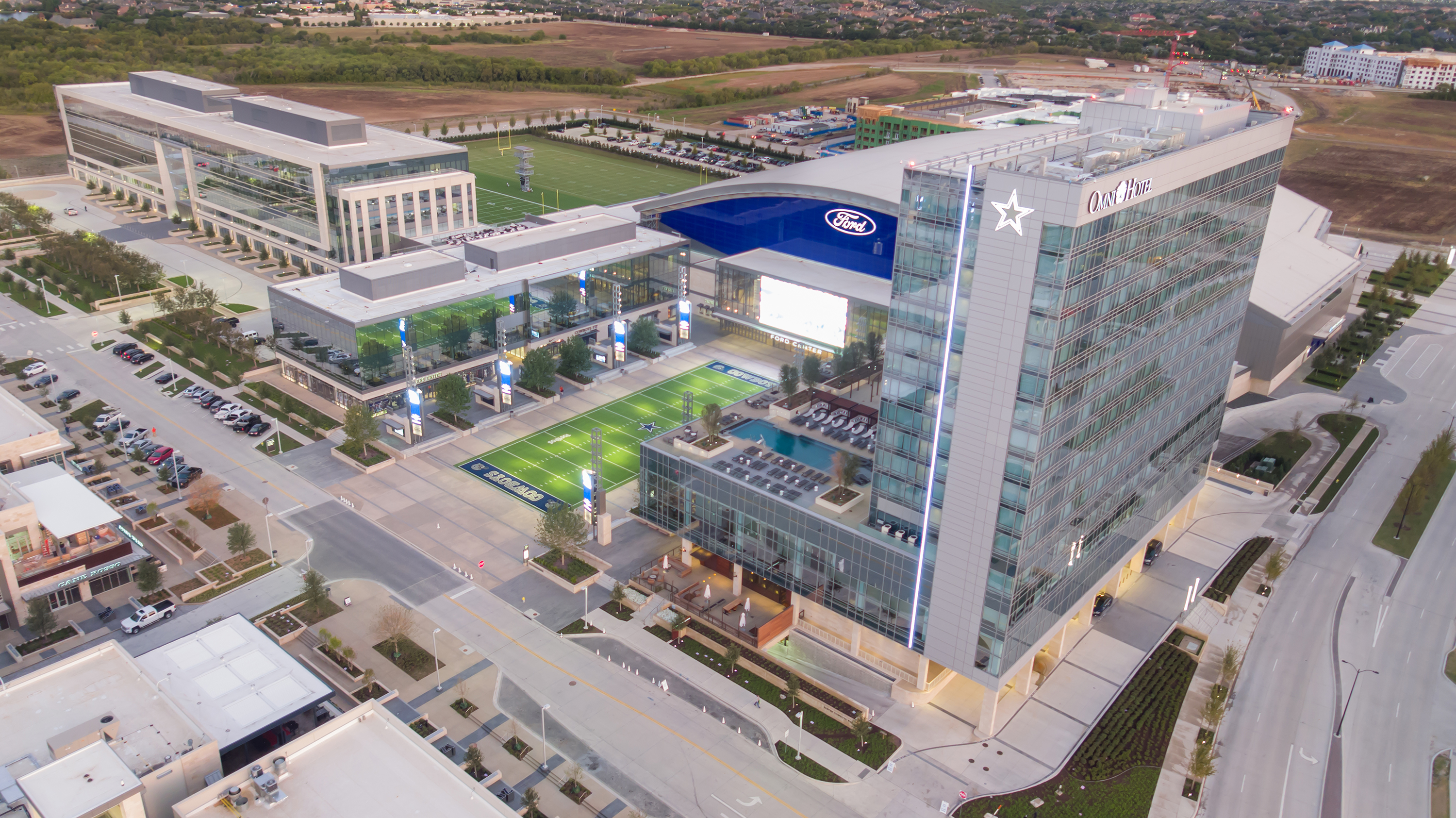 Aerial shot of the Omni Frisco Hotel, Ford Center at The Star, and Tostito's Plaza.