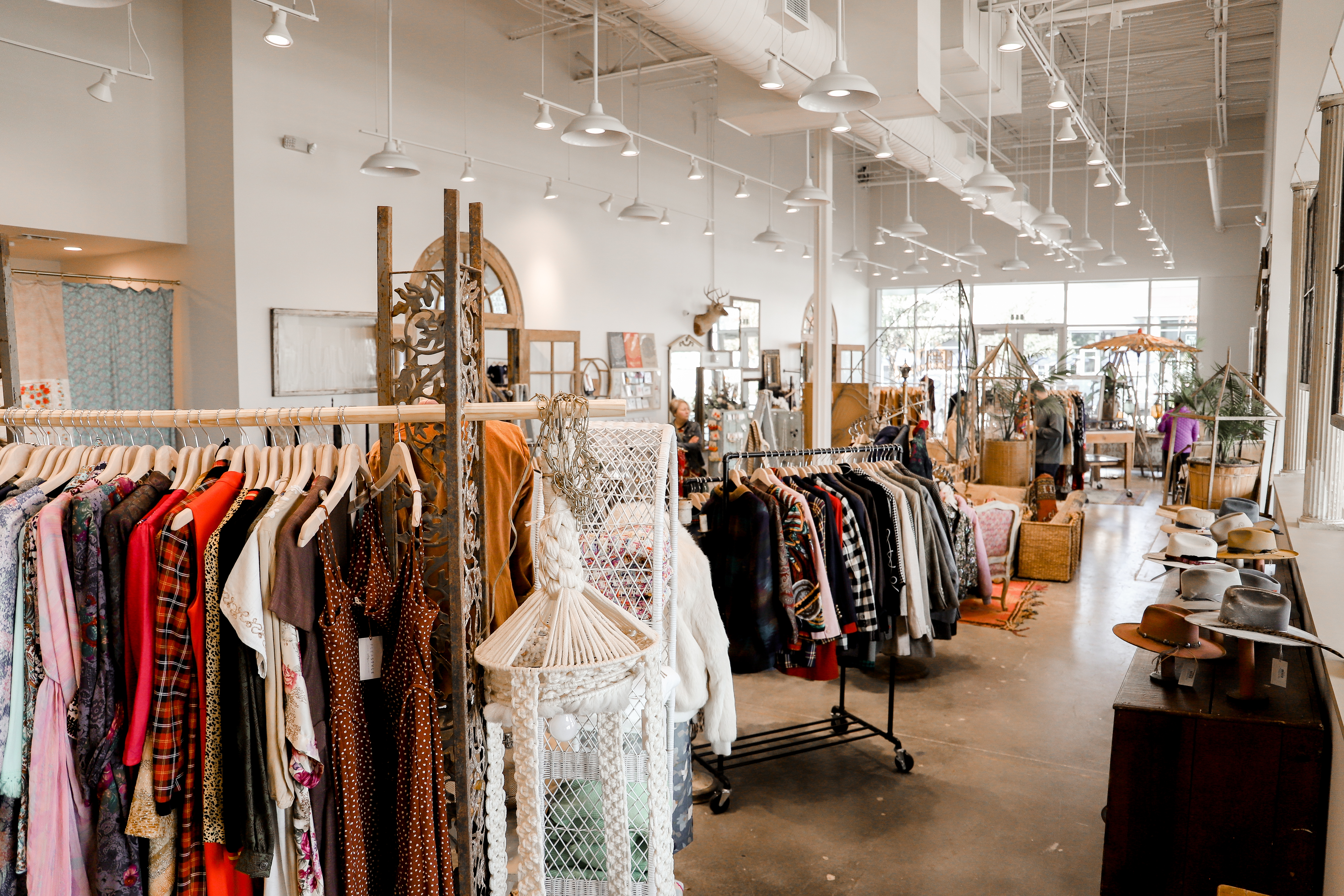 Racks of clothes and handmade hats inside Flea Style.