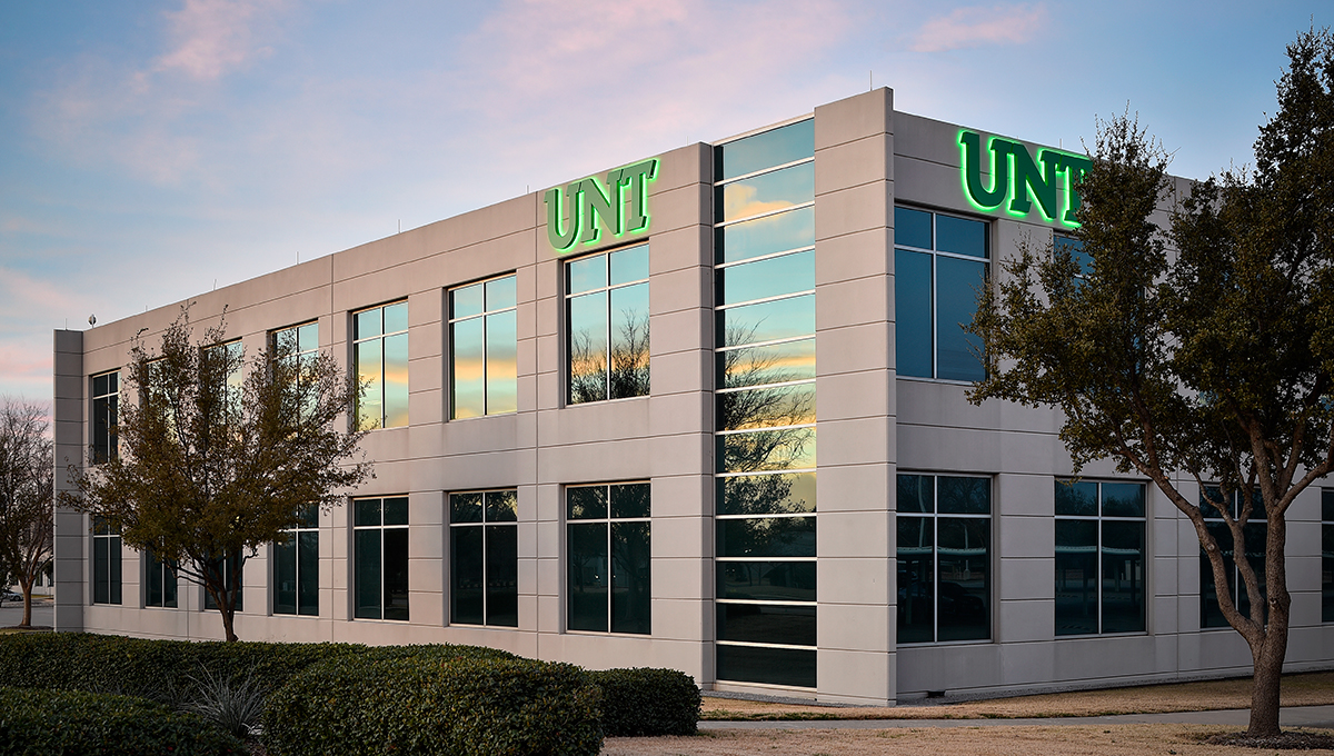 Two-story building with the green University of North Texas logo.