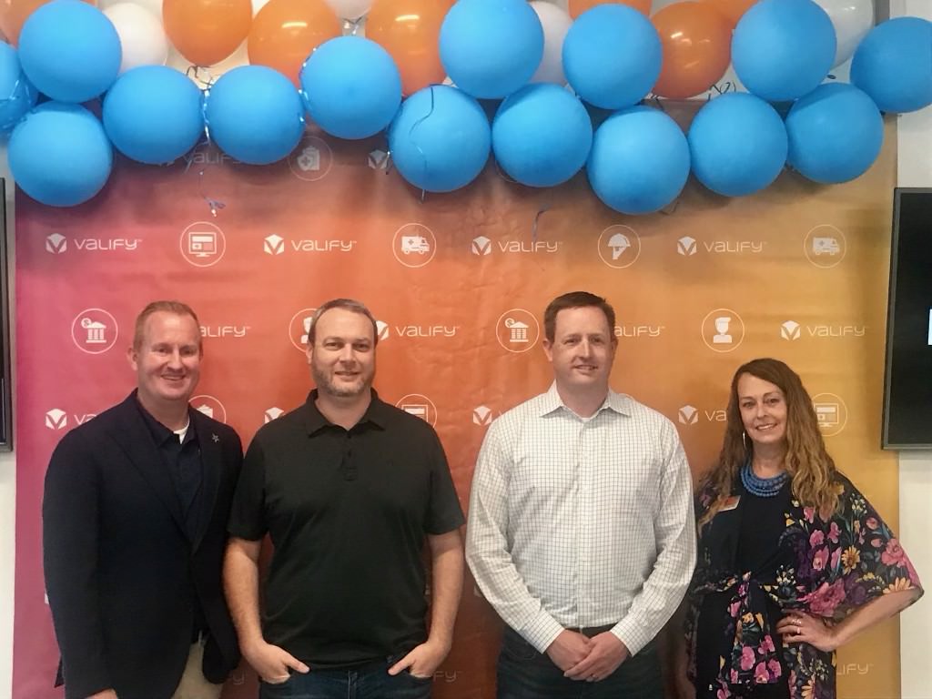 City of Frisco and Valify representatives pose for a photo in front of a background.